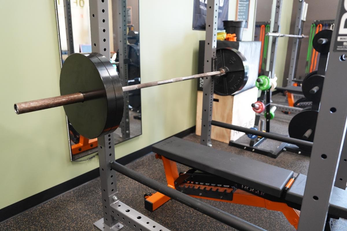 Loaded barbell racked at Elevate Barbell Club